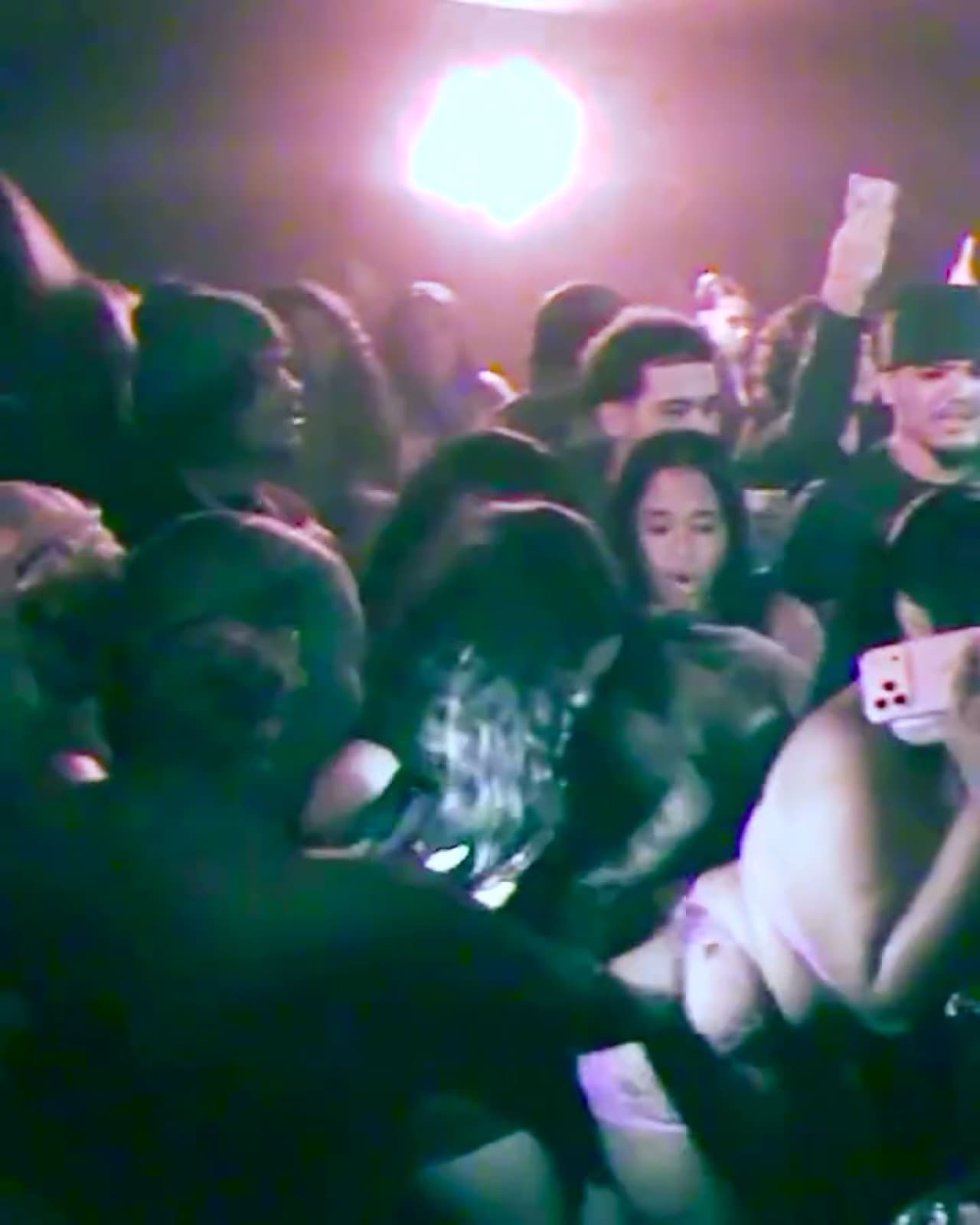 The crowd on the dance floor at Baby's under pink light