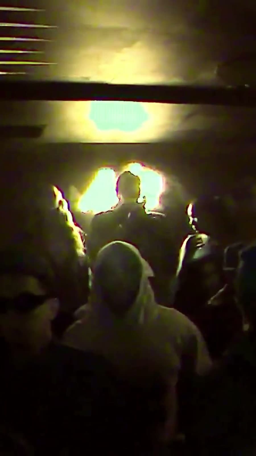The DJ booth at Baby's, backlit over a full room