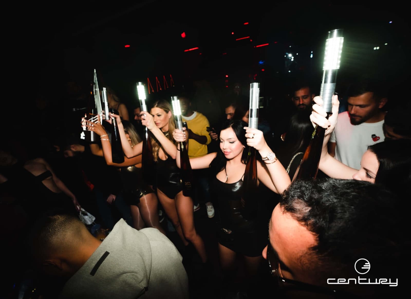 A bottle parade with sparklers through the crowd at Century