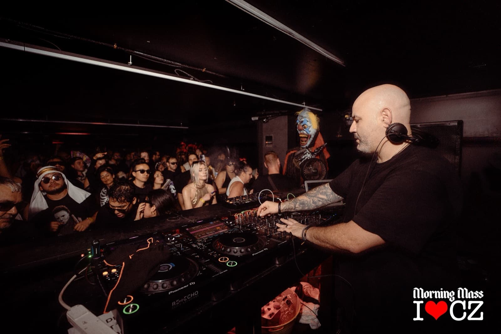 A DJ plays at the decks in front of a packed crowd at The Comfort Zone