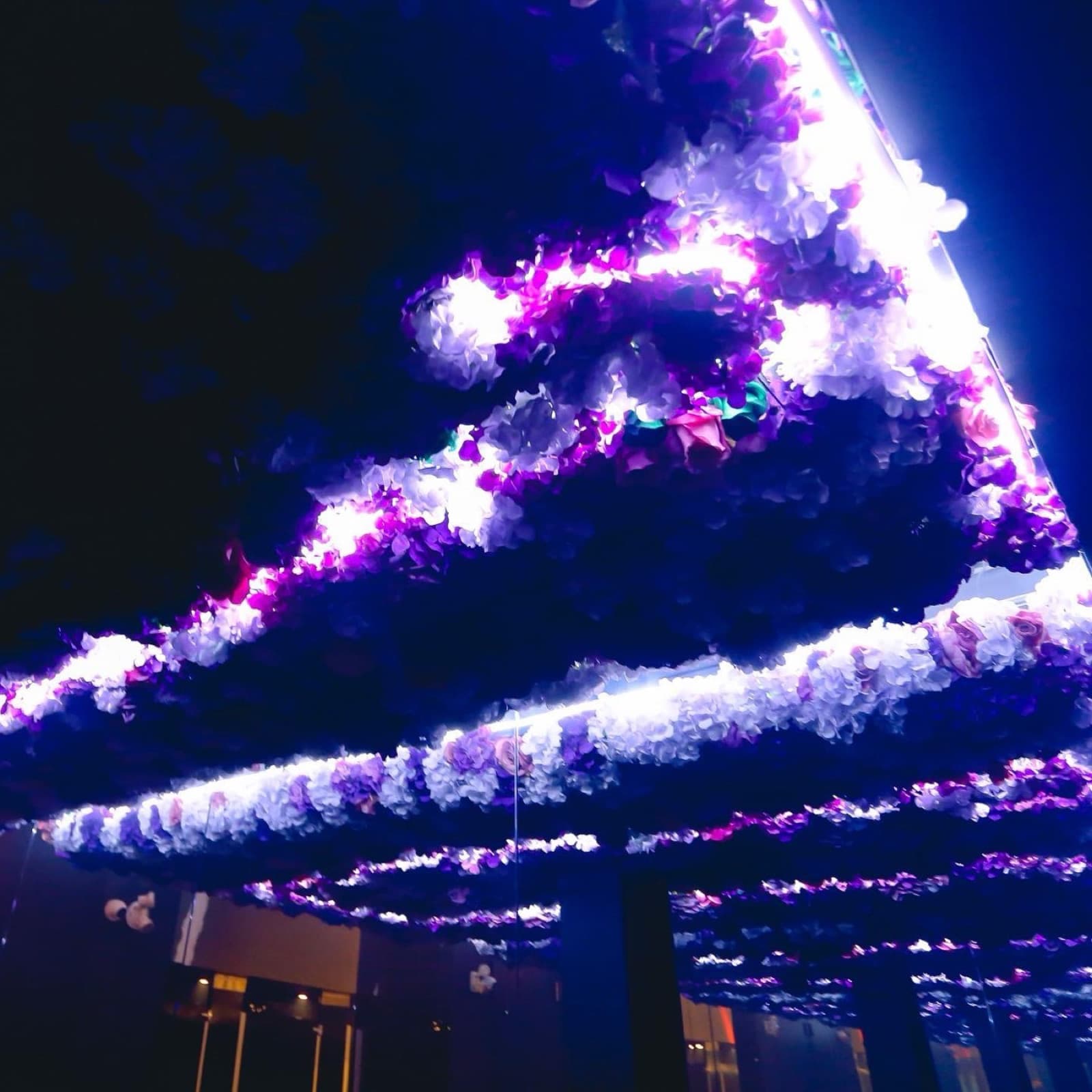 The floral light ceiling at Ultraviolet, in purple and white